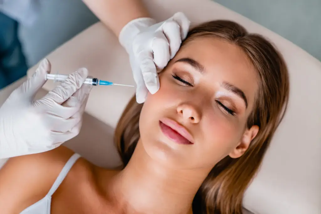 Woman receiving Botox injection in facial area by medical professional, highlighting cosmetic wrinkle treatment.
